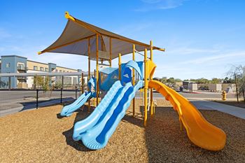 A playground with slides and a tent